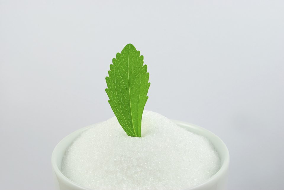 stevia sugar and a stevia leaf